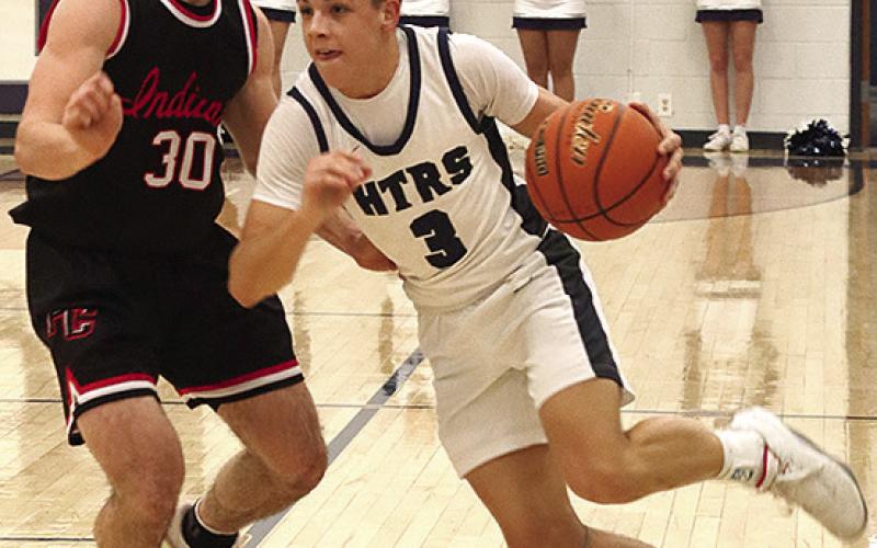 HTRS’ Kameon Dettmann (#3, right) brings the ball down against P.C.’s Jett Farwell (#30, left) in last Tuesday’s night’s game which HTRS won, 50-46. Paula Jasa/Republican