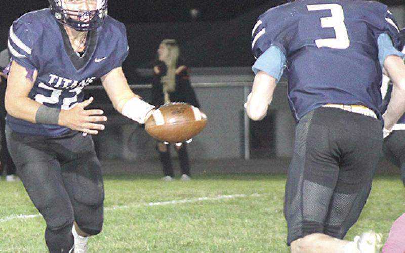 HTRS’ Hunter Bohling (#22, left) hands off to teammate Brogan Dunlap (#3, right) on a reverse run. Paula Jasa/Republican