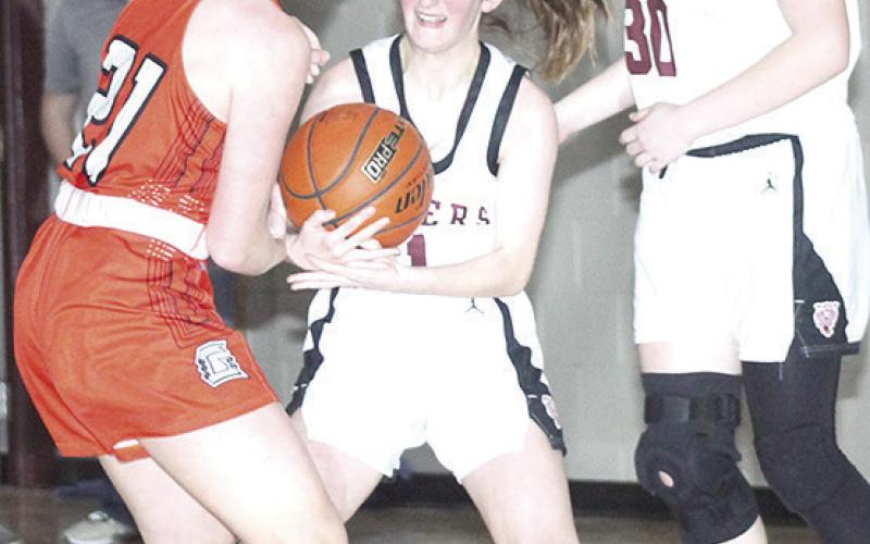 LHS’ Kierstin Rehrs (center) fights with a Diller/Odell player for possession as teammate Sara Wiles (#30, right) looks to help out. Paula Jasa/Republican