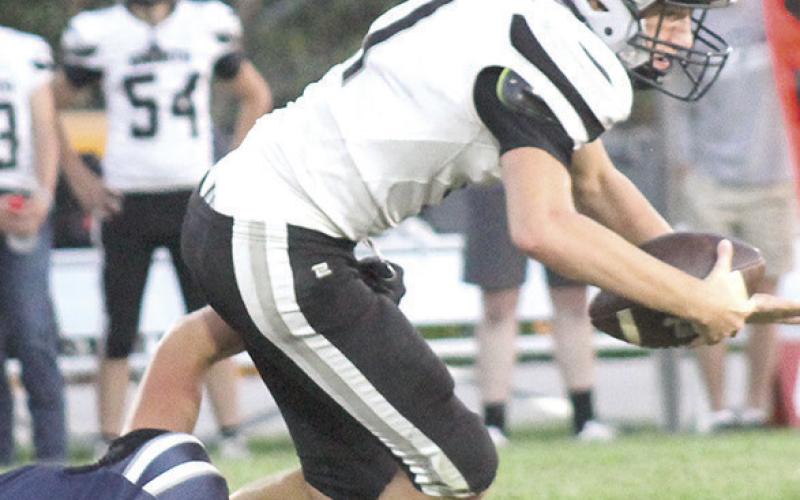 HTRS’ Emmett Glathar (#8, left) brings down the E-M quarterback on a 3rd down play. Glathar had several big plays in the game and led the Titans with 14 tackles, 1 sack and 1 fumble recovery. Paula Jasa/Republican