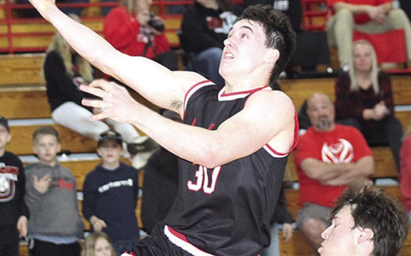P.C.’s Jett Farwell (#30, left) flies past an Eagle defender on his way in for an easy bucket. Paula Jasa/Republican