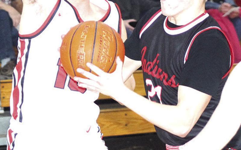 P.C.’s Trey Marteney (#21, right) goes hard in the paint in the game against Johnson-Brock last Thursday. Paula Jasa/Republican