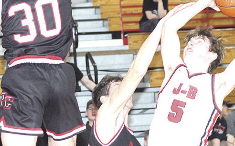 P.C.’s Oscar Machini (#40, center) and Jett Farwell (#30, left) team up on defense against J-B’s Camden Dalinghaus (#5, right). Paula Jasa/Republican