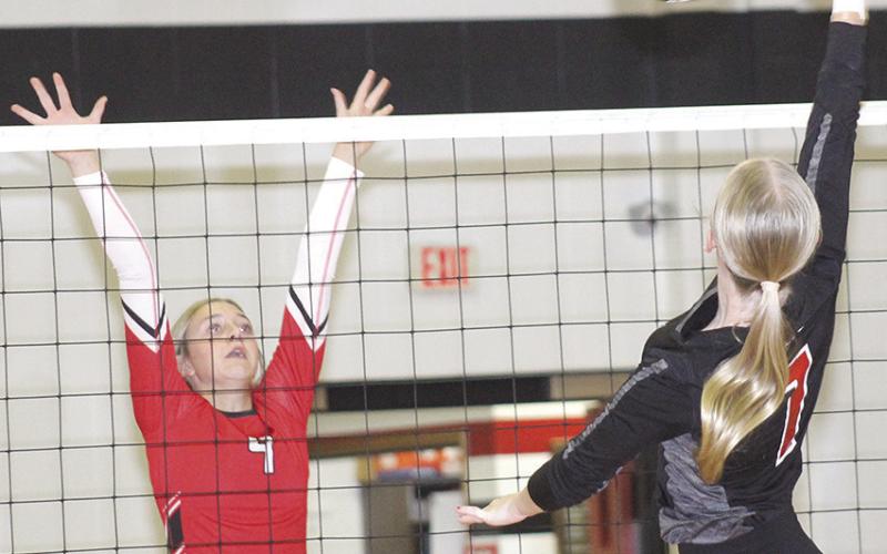 P.C.’s. Adrian deKoning (#7, right) powers a spike past a Wymore Southern blocker in last Tuesday’s match. P.C. won in straight sets, 25-15, 25-18. Paula Jasa/Republican