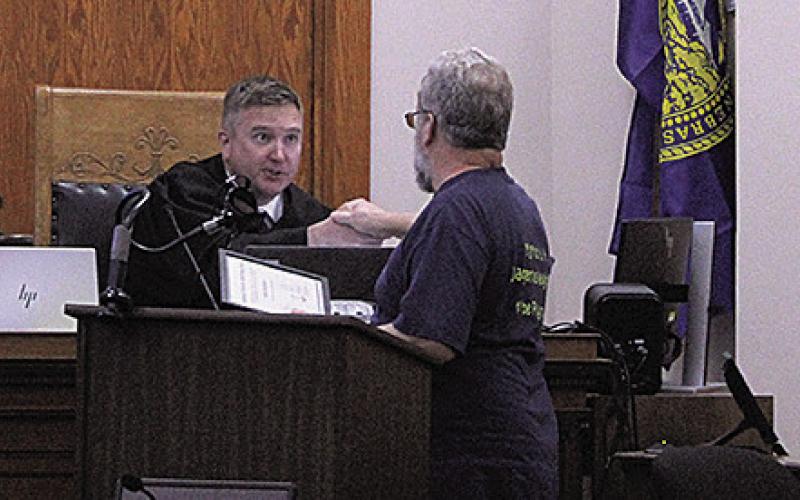 Ralph Schiffbauer (right) receives his certificate of completion from Judge Richard Smith (left)