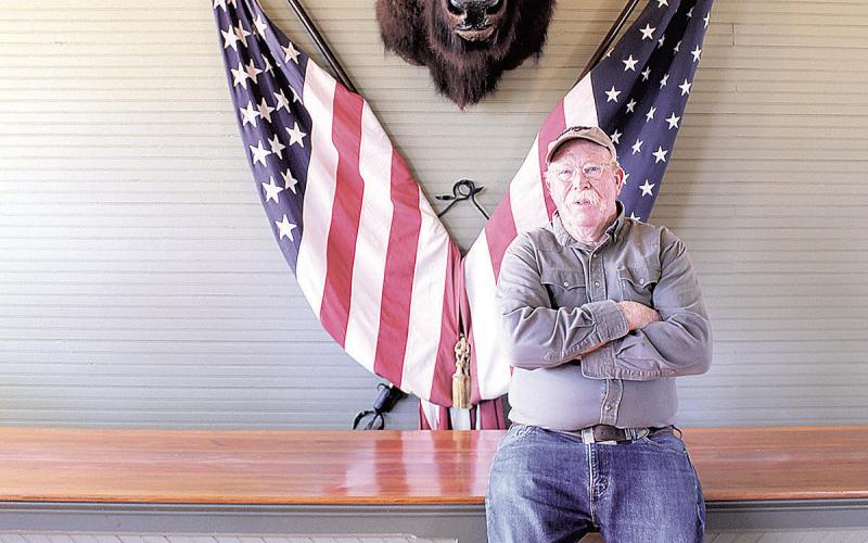 Jim Tegtmeier in his store with his prized buffalo head