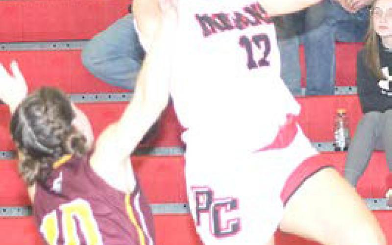 Pawnee City’s Neveah Blecha (#12, right) goes in for a left-handed layup attempt against a Sterling defender. Paula Jasa/Republican
