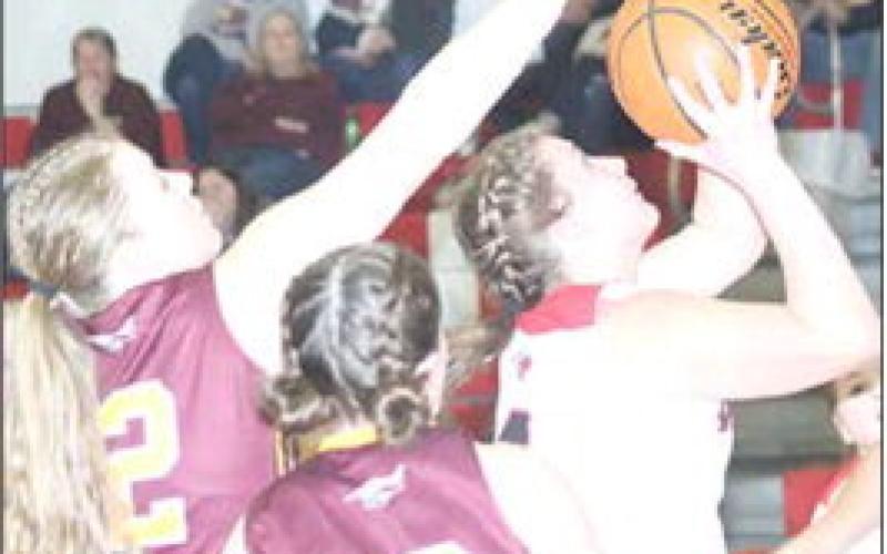 P.C.’s Cameron Ottersberg (#4, right) moves past Sterling defenders to put up a shot in the lane. Paula Jasa/Republican