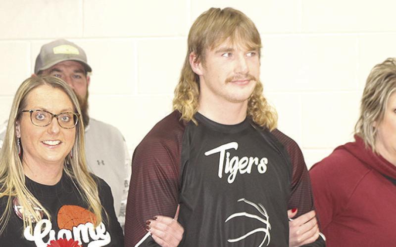LEWISTON PARENTS’ NIGHT - Tristen Ray is accompanied by his parents prior to the Lewiston vs. Sterling boys’ game on Friday night.