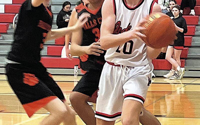 Colin Fender draws a double team as he fights for position in the paint. photo by Emily Norman