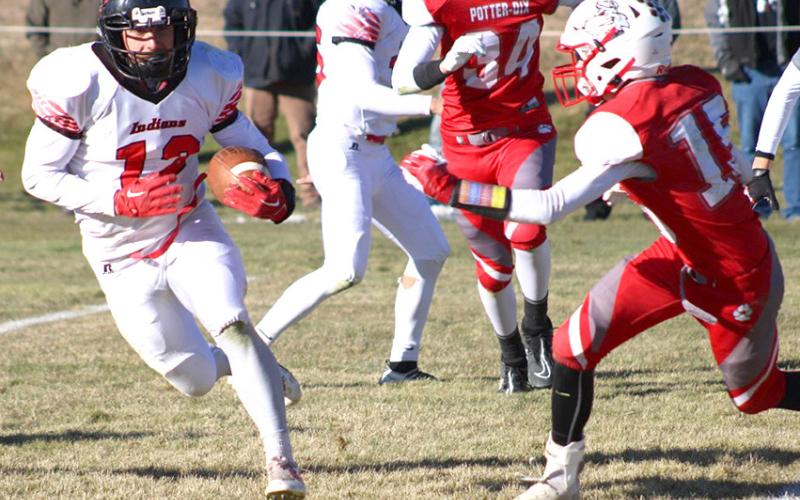 P.C.’s Andy Maloley (#12, left) takes off on a run against Potter-Dix in Friday’s quarterfinal game. Maloley had 19 carries for 163 yards and 3 TD’s in the game. photo courtesy of Jamie Maloley