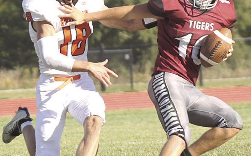LHS’ Everett Bohling (#10, right) eludes a Griffin tackler and rolls back to the right side of the field to complete a touchdown pass right before the halftime break. Paula Jasa/Republican