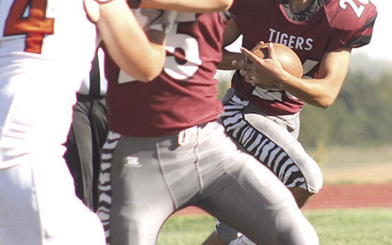 LHS’ Alexander Seeman (#26, right) looks to get past the D/O defense with the help of teammate Brock Janssen (#25, center) in Lewiston’s Homecoming game. Paula Jasa/Republican