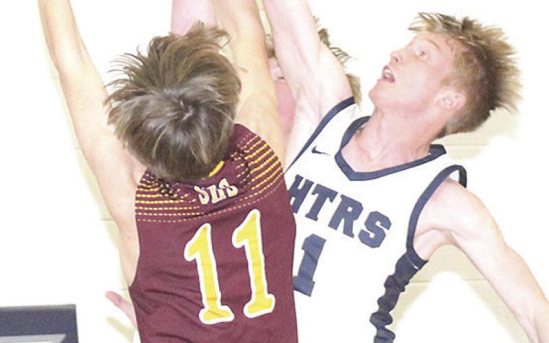 HTRS’ Brogan Dunlap (#1, right) gets his hand on a block against a Sterling shooter on Friday night. Paula Jasa/Republican
