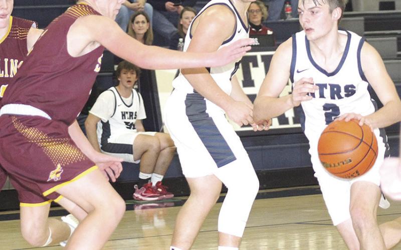 HTRS’ Brennen Vaughan (#2, right) drives past a Sterling defender and teammate Hunter Bohling (center) on his way to the hoop. HTRS defeated Sterling 47-34. Paula Jasa/Republican