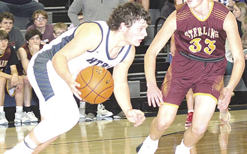 HTRS’ Hunter Bohling (left) takes off on a drive past a Sterling defender on Friday night. Bohling scored 10 points and had 10 rebounds for a double double. Paula Jasa/Republican