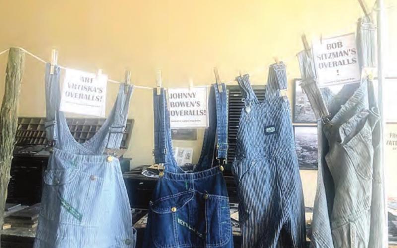 Overalls on clothesline at exhibit entrance.