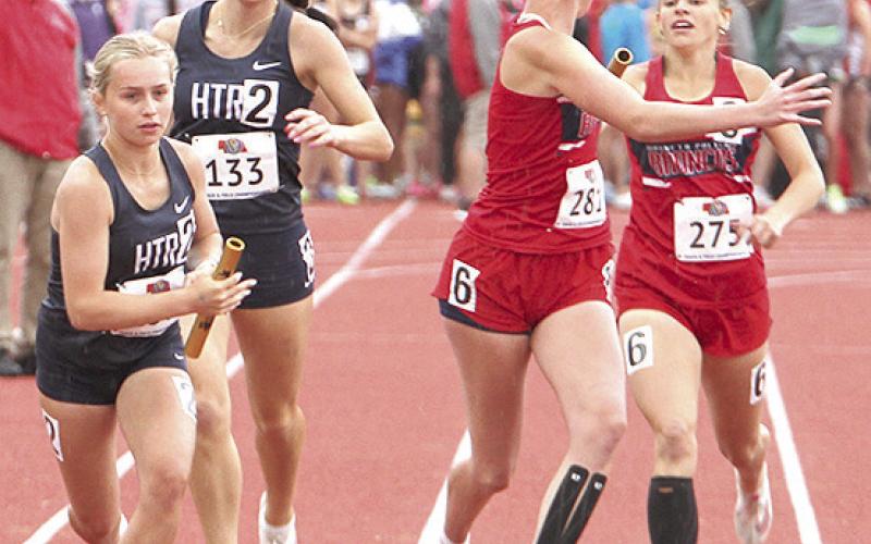 HTRS’ Miranda Rist (left) takes the handoff from teammate Lillian Bowen (#133) in the Class D girls’ 1600 M. Relay on Saturday. Photo courtesy of Stephanie Croston/Seward County Independent