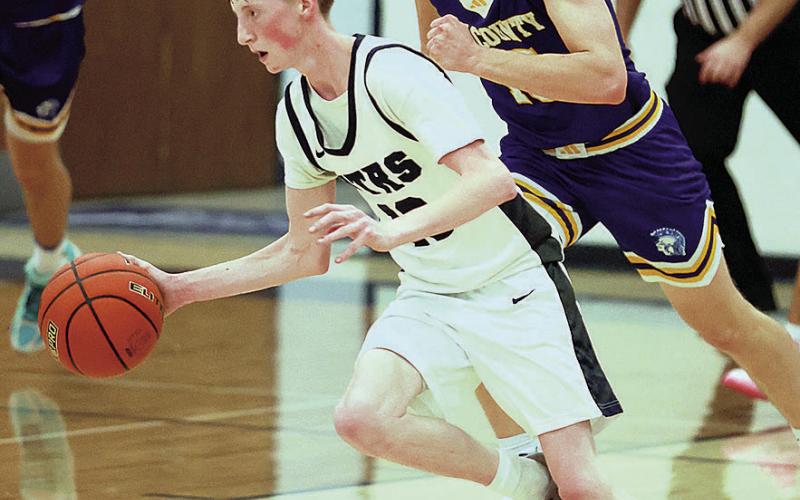 HTRS Titan Garrett Duryea runs with the ball as Tri County Trojan Jason Wehrman pursues Photo by Lorrie Novak