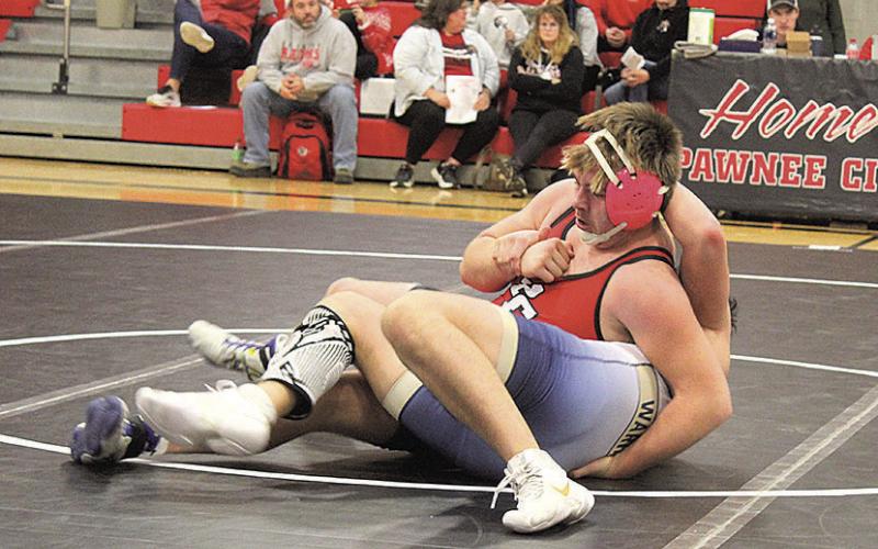 Pawnee City Indian Gauge Schuetz pins Lincoln Lutheran Warrior Bowen L’Heureux to win the match.