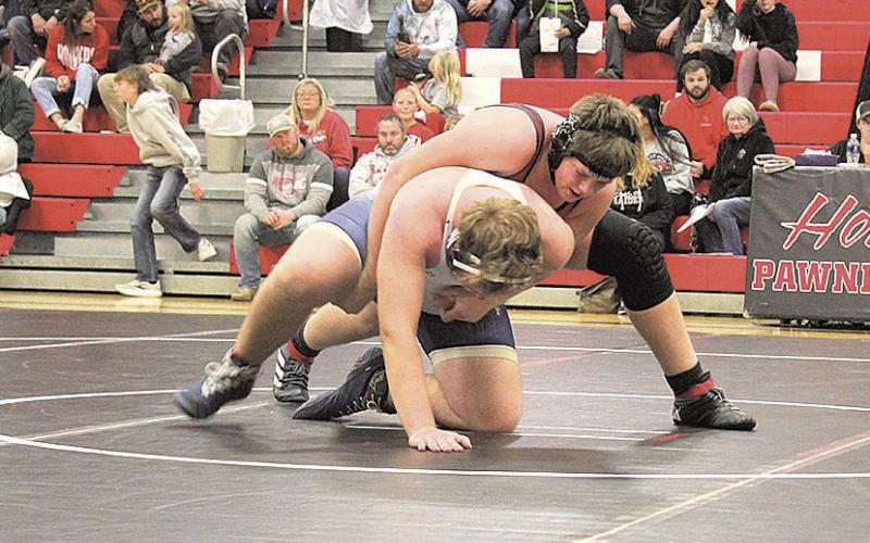 Pawnee City Indian Joel Strehle begins another round against a Lincoln Lutheran Warrior.