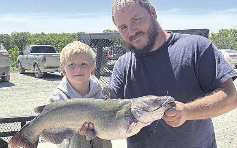 Brandon Holthus and son Leon enjoying their catch of the day during the 3rd Annual Klepper and Sons Annual Kids Fishing Derby