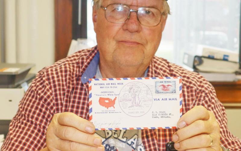 Larry Bradbury holds up his 1938 Airmail stamped letter which has a stamp of the Pawnee County Fair, known then as The Little State Fair. Ray Kappel/Republican