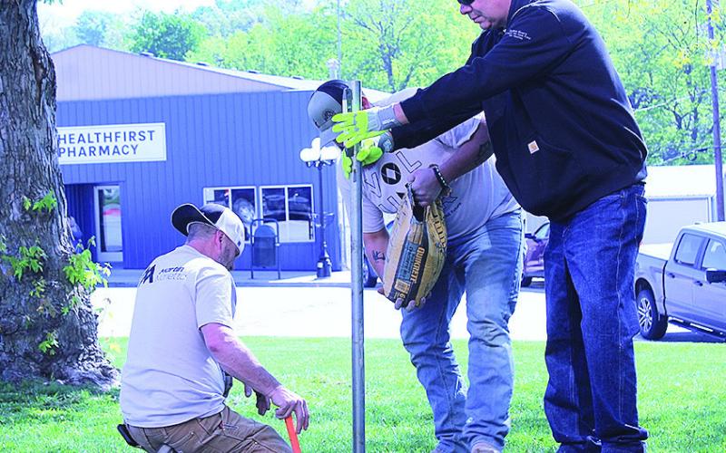 Volunteers Install New Flag Poles On Courthouse Lawn
