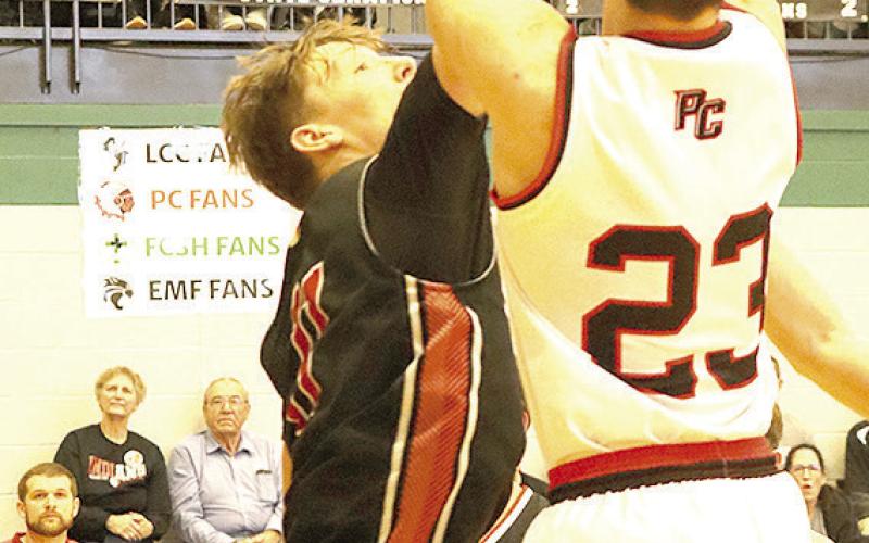 P.C.’s Anthony Kling (#23, right) pulls up on the baseline for a shot over Wymore-Southern. Paula Jasa/Republican