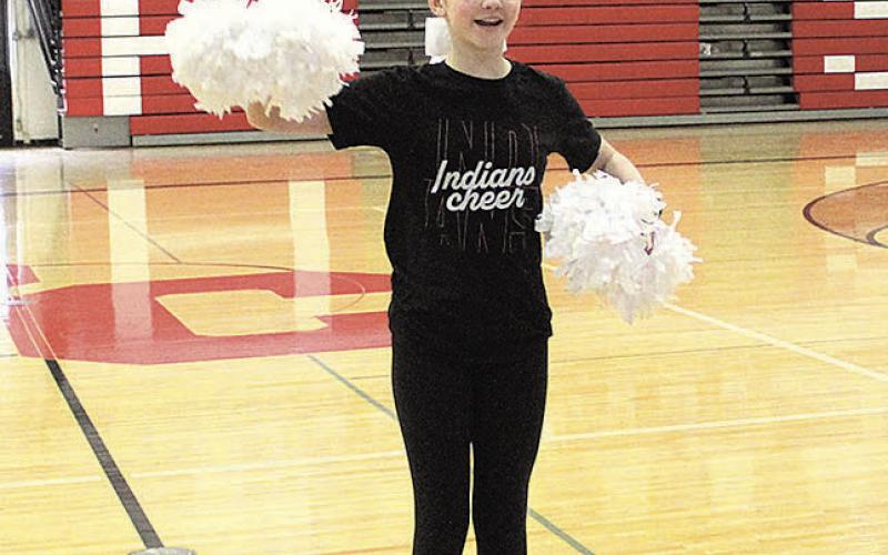 Cheerleader Ella Wernimont leads her schoolmates in cheers at the Pawnee City wrestling pep rally