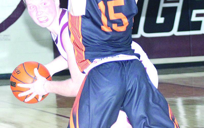 LHS’ Caleb Rule (left) peeks into the corner against a Diller/Odell player in Friday night’s game. Paula Jasa/Republican