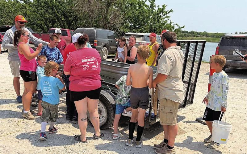 Anticipation grows as the kids bring their fish to the weigh-in.