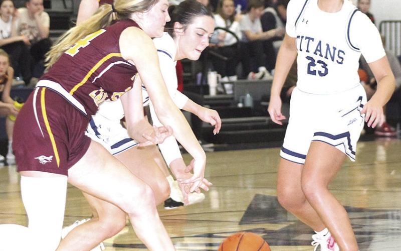 HTRS’ Lillian Bowen (center) goes for a loose ball against Sterling as teammate Jaylie McNealy (#23, right) looks to help out. The Lady Titan defeated the Lady Jets on Friday night by a 48-38 score. Paula Jasa/Republican