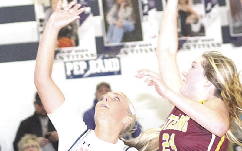 HTRS’ Jaylie McNealy (#23, left) goes up for an easy shot against a Sterling defender in Friday night’s game. Paula Jasa/Republican