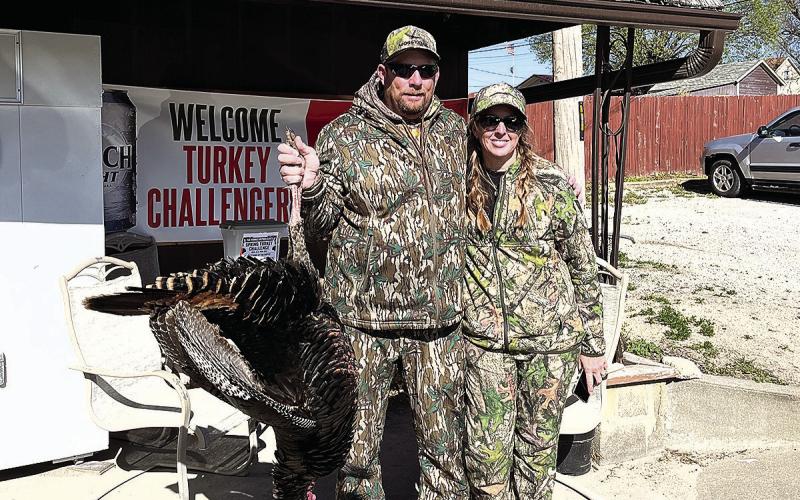 Michael Carpenter (left) poses with his wife and his