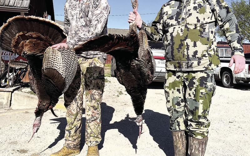 Bo Henry (left) and his dad Casey (right) hold their birds