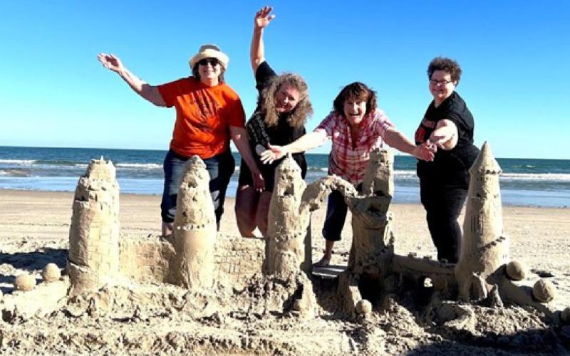 Sisters Sandy Cerra, Suzanne Ellis, Sharla Sitzman, and Sherry Winkinhofer with their 2022 sandcastle