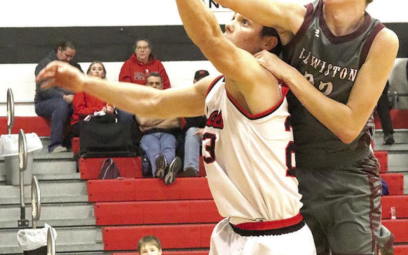 P.C.’s Anthony Kling (#23, left) and LHS’ Ashton Sanders (#23, right) battle for a rebound under the basket, but Sanders draws the foul on the play. Paula Jasa/Republican