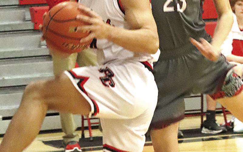 Paula Jasa/Republican P.C.’s Atreyu Kling (left) brings down a rebound against LHS’ Ashton Sanders (#23, right).