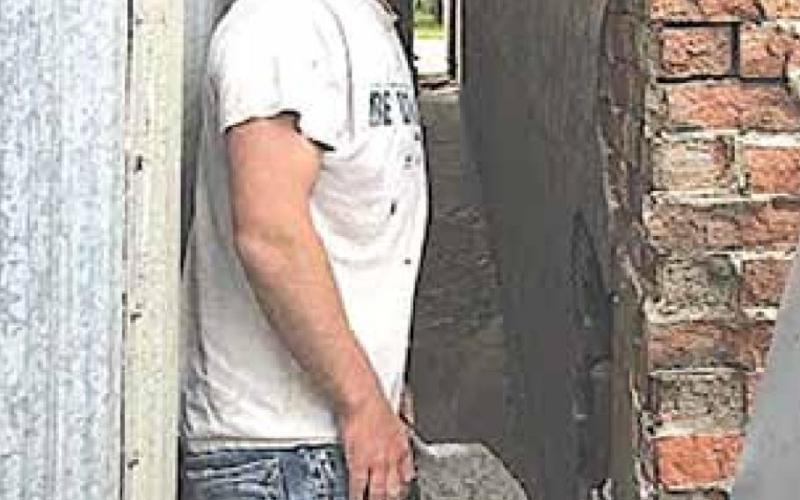 Brick mason Brandon Schawang doing some critical repair at the back of the building. Sharla Sitzman Photo