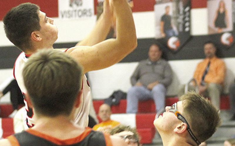Paula Jasa/Republican P.C.’s Anthony Kling (left) soars through the lane past two Diller/Odell defenders. Kling amassed 30 points against the visiting Griffins in the Indians’ 57-40 victory.