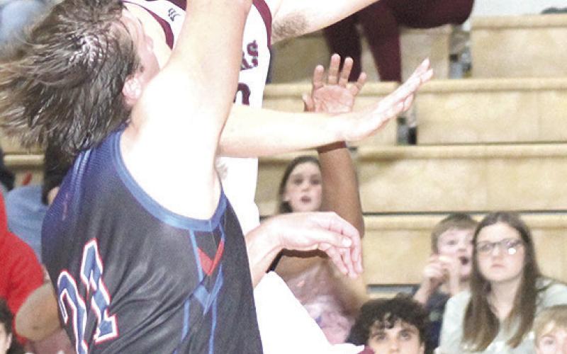 LHS’ Everett Bohling glides in for quick layup as the buzzer sounds at the end of the 3rd period. Bohling led Lewiston with 26 points in their thrilling 66-61 victory. Paula Jasa/Republican