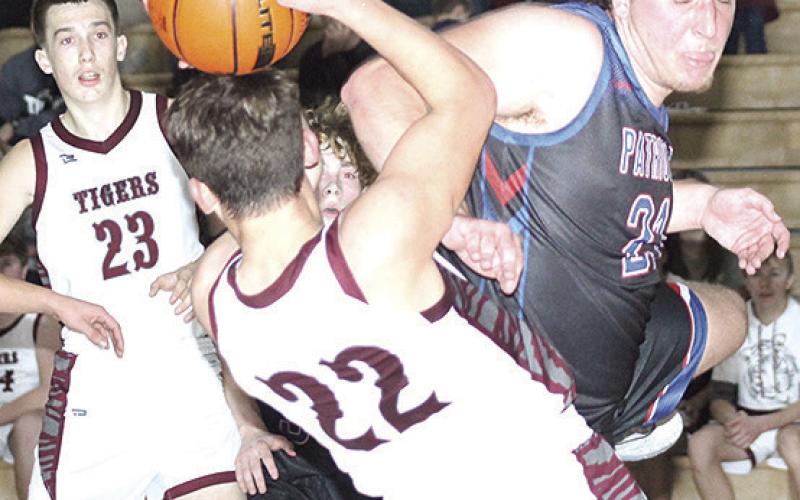 LHS’ Brock Janssen (#22) gets fouled during a rebound while teammate Ashton Sanders (#23) looks on. Paula Jasa/Republican
