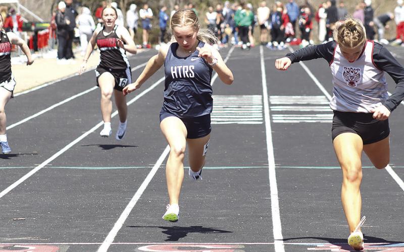 Lewiston’s Justice Currie (right) crosses the finish line just ahead of HTRS’ Miranda Rist (center) in the girls’ 100 M. Dash prelims. Also pictured (from left) are Pawnee City’s Ericca Gyhra and Dakota Dean. Paula Jasa/Republican
