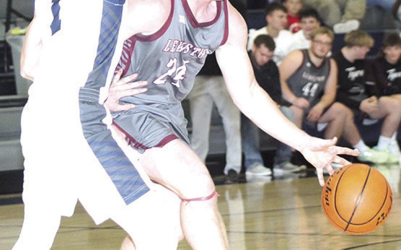 LHS’ Tristen Ray (#24, right) drives the ball at the top of the key as HTRS’ Brogan Dunlap (#1, left) defends. Paula Jasa/Republican