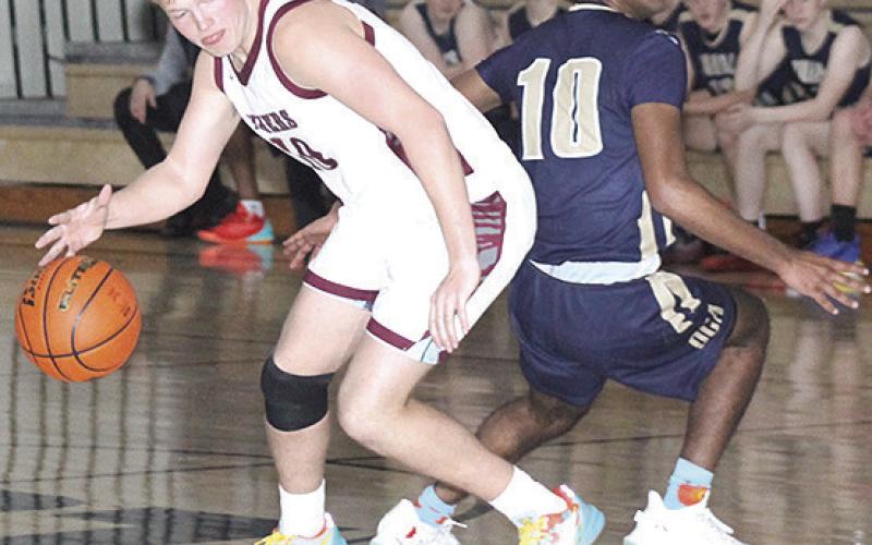 LHS’ Everett Bohling (#10, left) fakes out his OCA opponent on his way down the court. Bohling scored 20 points to lead the Tigers in Saturday’s game. Paula Jasa/Republican