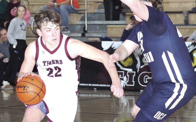 LHS’ Brock Janssen (#22, left) drives the lane past an OCA defender in the Tigers’ 66-45 victory on Saturday. Janssen scored 10 points in the game. Paula Jasa/Republican