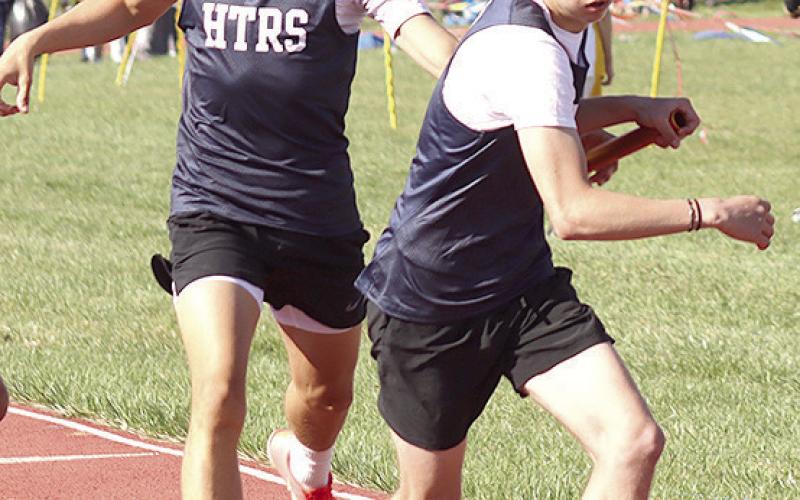 HTRS’ Axton Wamsley takes the handoff from teammate Kameon Dettmann in the boys’ 1600 M. relay. Paula Jasa/Republican