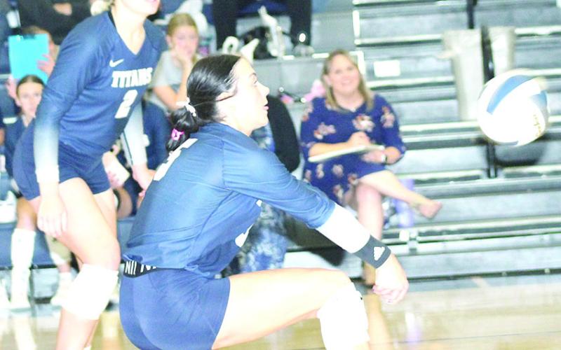 HTRS’ Lillian Bowen (#5) directs a pass to the front row as teammate Elie Bstandig (#2, left) looks on in a three-set match against E-M-F last Monday at the Pioneer. Paula Jasa/Republican