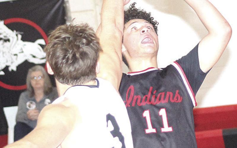 P.C.’s Darius Andersen (#11, right) goes up for a bucket underneath in Saturday consolation action. Paula Jasa/Republican